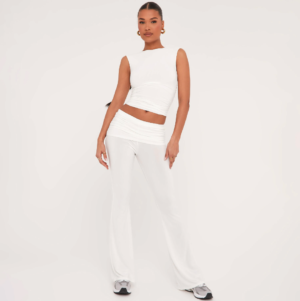 HIGH NECK SLEEVELESS TOP AND LOW RISE FOLD OVER FLARED TROUSERS CO-ORD SET IN WHITE SLINKY